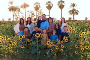 Family of 12 in sunflower fields