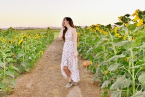 teen in sunflower field