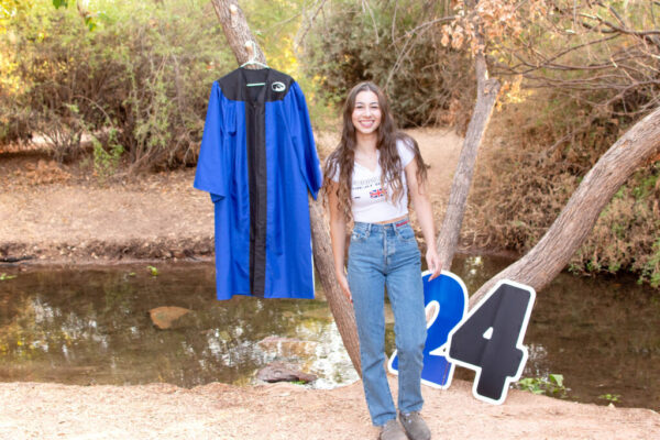 2024 Graduate Photoshoot with large 24 numbers and girl in jeans and tshirt