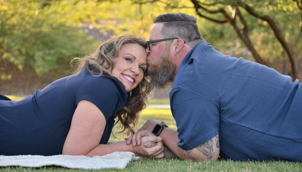 Cute couple in blue man kissing womans head. Buckeye,AZ. Photo by amazing avondale photographer