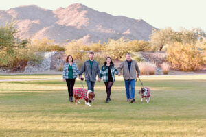 family of 4 in Buckeye, AZ walking with two australian shepards. 