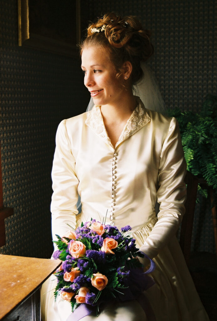 Woman in wedding dress looking out window in buckeye az