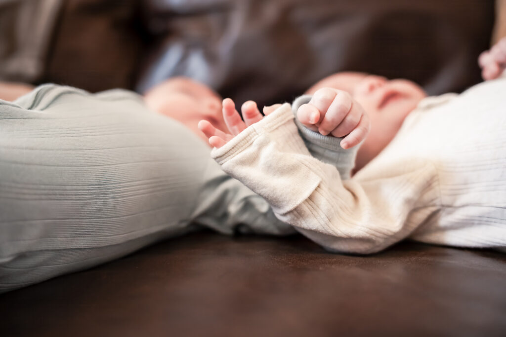 Sweet baby twins arms intertwined