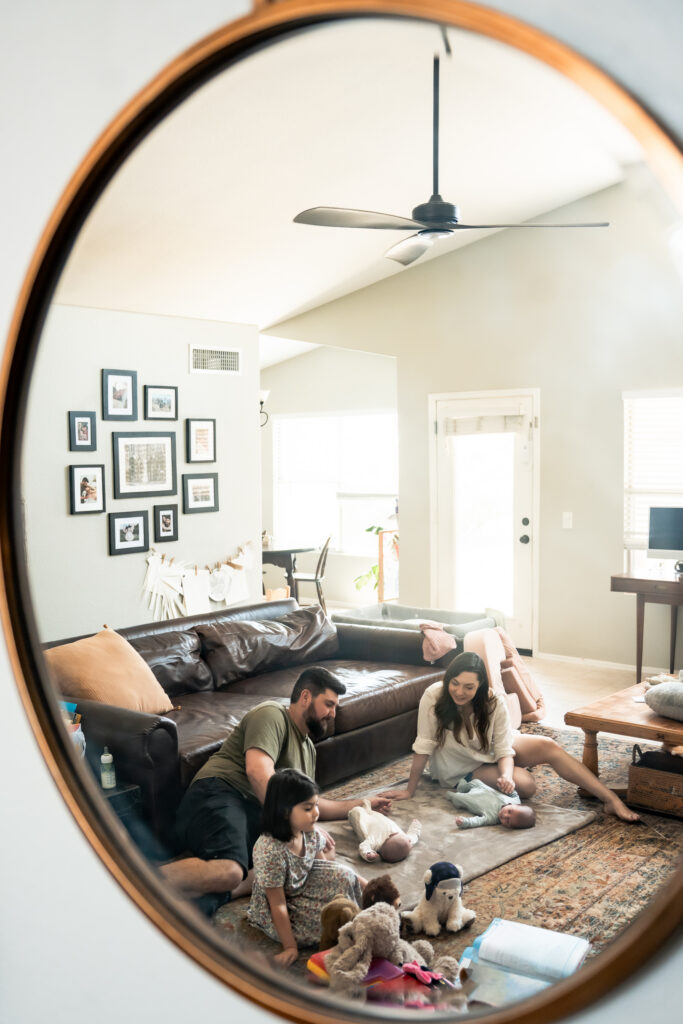 Sweet family in the livingroom through the mirror